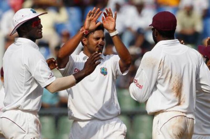 West Indies' Ravi Rampaul (C) celebrates with his team captain Darren Sammy (L) and Kirk Edwards after dismissing India's VVS Laxman during the fifth day of their third and final test cricket match in Mumbai November 26, 2011. REUTERS/Vivek Prakash (INDIA - Tags: SPORT CRICKET) *** Local Caption ***  MUM63_CRICKET-WINDI_1126_11.JPG