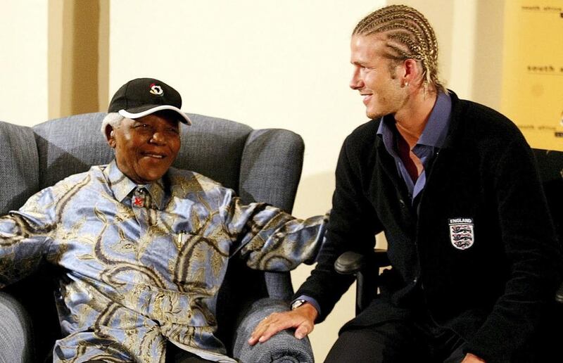 Mandela chats with England's football captain David Beckham in 2003. Juda Ngwenya / Getty Images