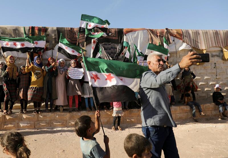 Abdelsalam al-Youssef, director of Teh displaced camp in northern Idlib, takes a selfie during a protest against the closure of Bab al-Hawa crossing in the opposition-held Idlib, Syria June 7, 2021. Picture taken June 7, 2021. REUTERS/Khalil Ashawi