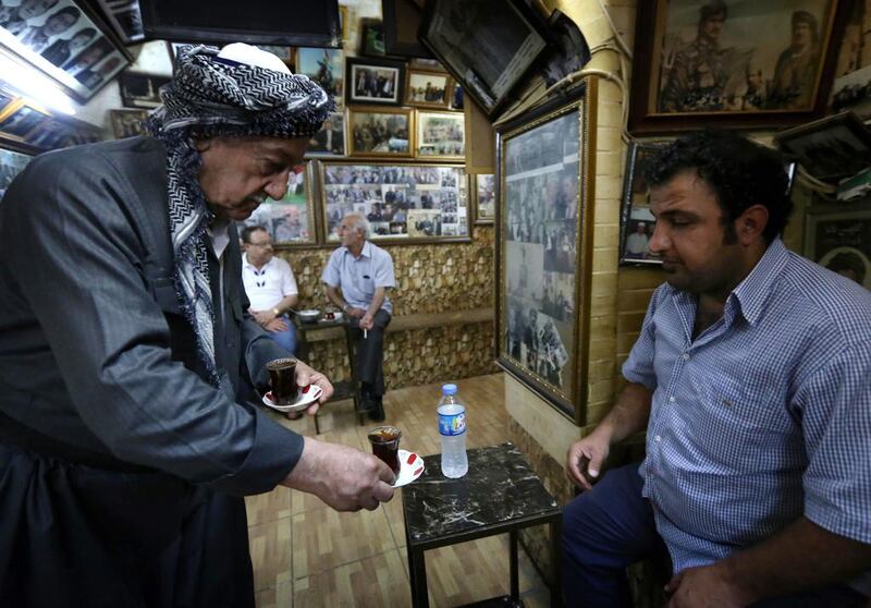 The 96-year-old began collecting them, turning the cafe into a gallery awash with photos that portray Iraq as it moved through monarchy, dictatorship and into its current fragile democracy. Safin Hamed / AFP  