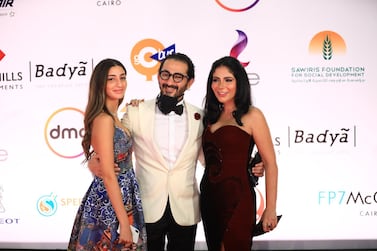 Egyptian actors Ahmed Helmy, centre, and Mona Zaki, right, attend the opening ceremony of the 42nd Cairo International Film Festival (Ciff), in Cairo, Egypt. EPA