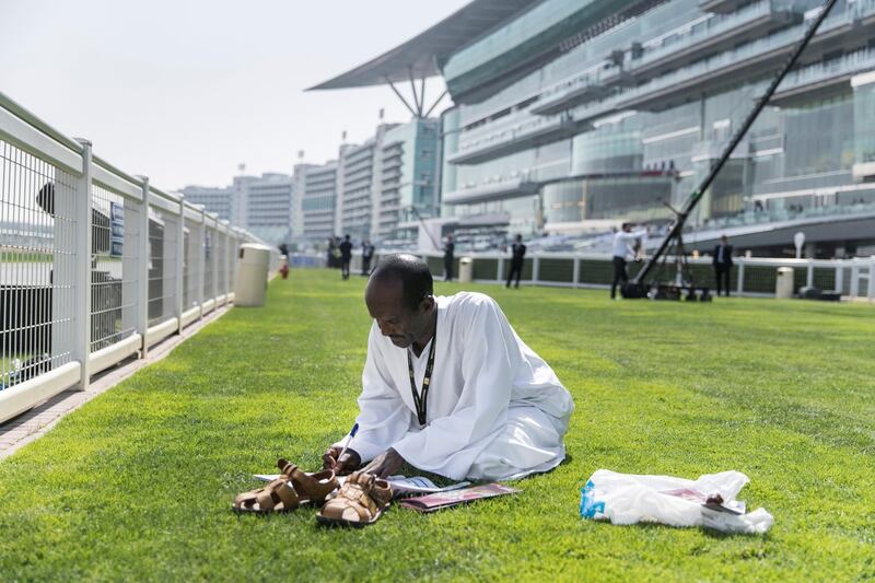 DUBAI, UNITED ARAB EMIRATES - MARCH 31, 2018. 

A man marks his bets at Dubai World Cup 2018.

(Photo by Reem Mohammed/The National)

Reporter: 
Section: NA