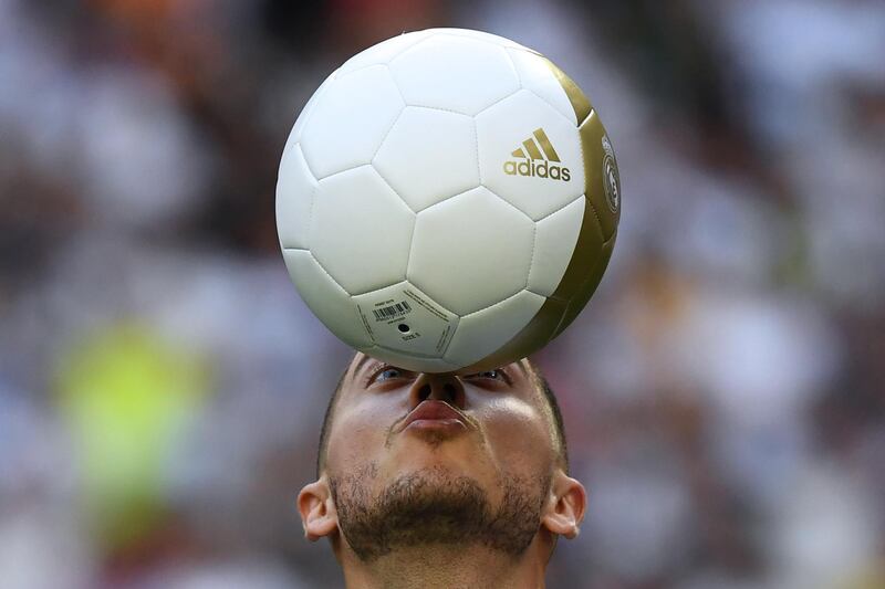 Eden Hazard balances a ball during his unveiling as a Real Madrid player. AFP