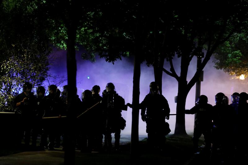 Law enforcement officials walk down a residential street after firing tear gas at protesters after Jason Stockley, a former St. Louis police officer, was acquitted of murder in the 2011 fatal shooting of Anthony Lamar Smith, a black man suspected of dealing drugs, in St. Louis, Missouri.  Whitney Curtis / Reuters.