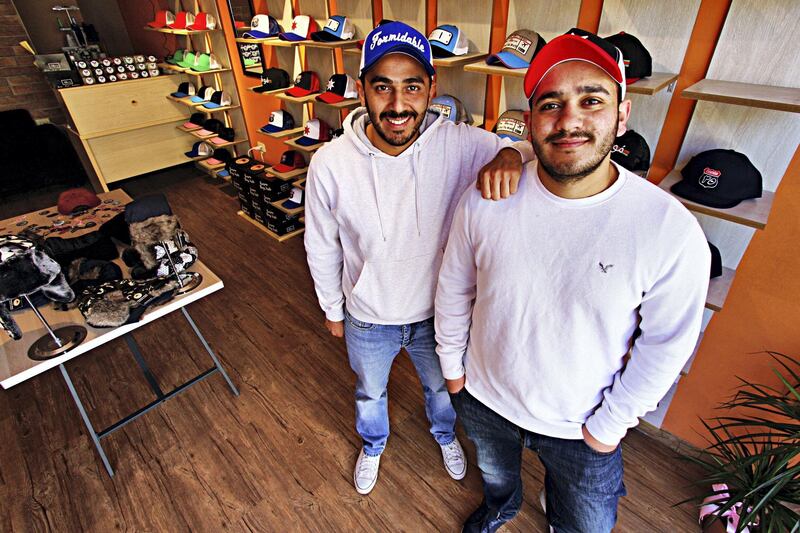 Childhood friends Hareth Hijazi and Abed Qwaider quit well-paying jobs to run a business creating customised caps together. Photo: Charlie Faulkner