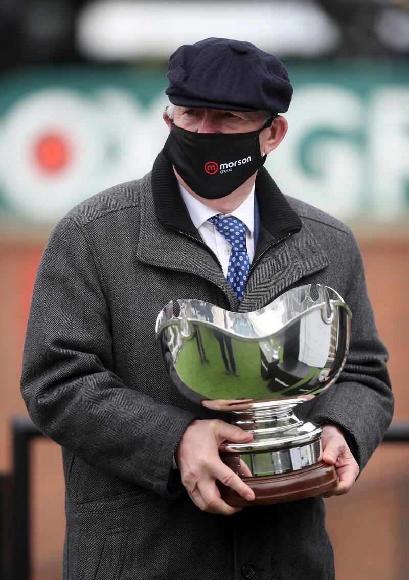 Alex Ferguson, owner of Clan Des Obeaux collects the Bowl Chase trophy at Aintree Racecourse. PA