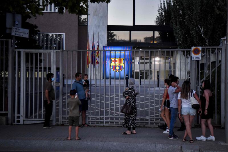 FC Barcelona's supporters gather in front of the entrance of the Camp Nou on Thursday.