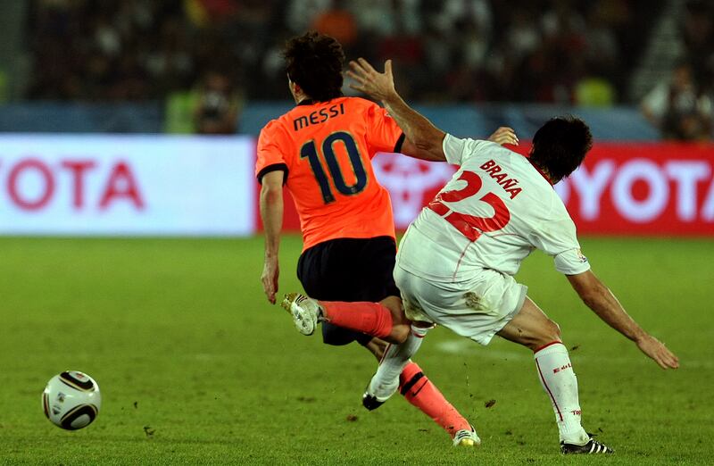 Barcelona's Lionel Messi is challenged by Rodrigo Brana of Estudiantes. AFP