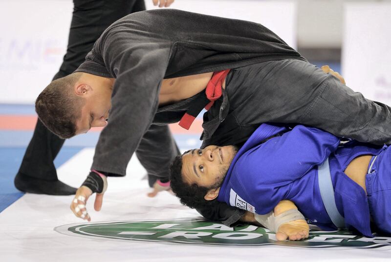 ABU DHABI , UNITED ARAB EMIRATES, September 29 , 2018 :- Khalid Ahmed ( blue ) of Al Ain Jiu-Jitsu Club and Abdullah Al Kubaisi ( black ) of Al Wahda Club during the Final game of men 110 kg category in the Jiu-Jitsu President’s Cup Round -1 held at Al Jazira Club Indoor stadium in Abu Dhabi. Khalid Ahmed won the final game. ( Pawan Singh / The National )  For Sports. Story by Amith