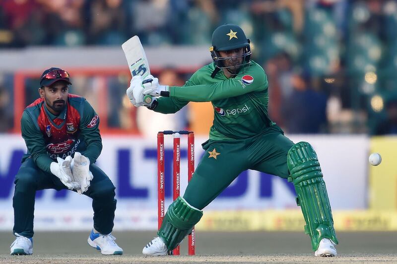 Pakistan's Shoaib Malik(R) plays a shot as Bangladesh's wicketkeeper Liton Das looks on during the first T20 international cricket match of a three-match series between Pakistan and Bangladesh at Gaddafi Cricket Stadium in Lahore on January 24, 2020.  / AFP / ARIF ALI
