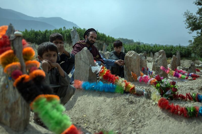 Familes sit by the graves of their relatives, decorated with garlands, and freshly dug just over a week ago. The pain sits deep here in Jawari village, Nangarhar, from where seven people had been killed who were working on the pine nut harvest. 