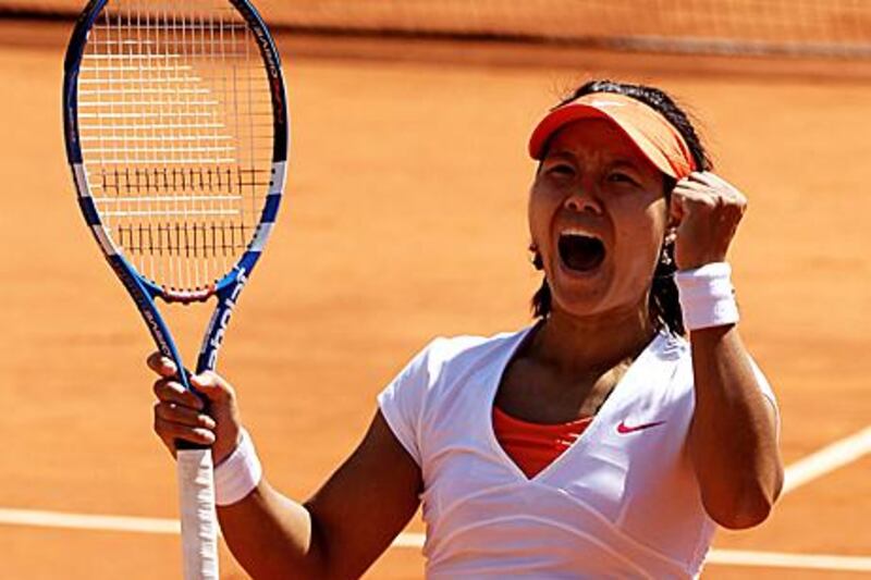 Li na roars in celebration at the French Open after reaching her second successive major final at the expense of Maria Sharapova.