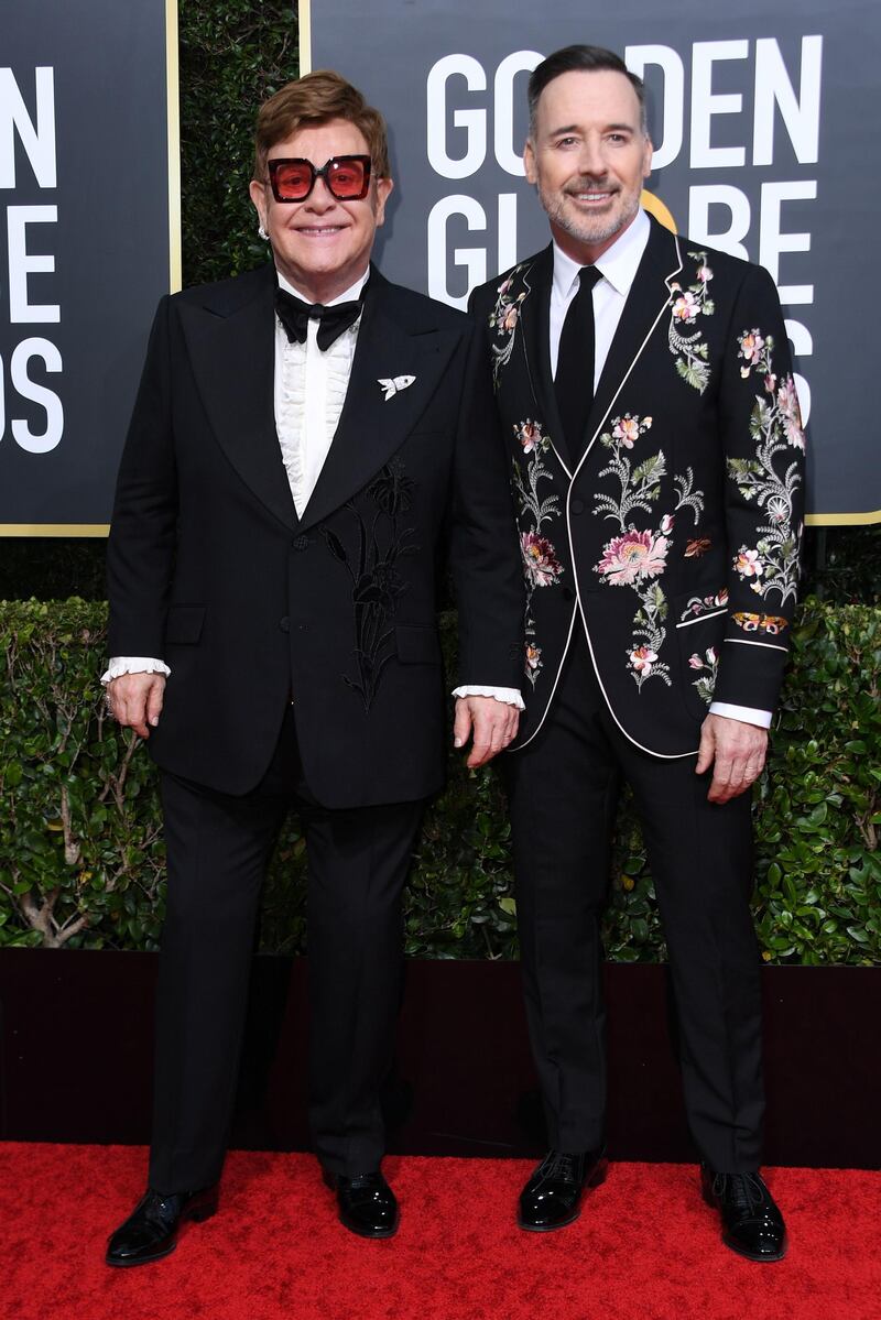 Elton John, wearing Gucci, and David Furnish arrive at the 77th annual Golden Globe Awards at the Beverly Hilton Hotel on January 5, 2020. AFP