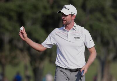 Webb Simpson holds up his ball on the 18th green during the second round of The Players Championship golf tournament Friday, May 11, 2018, in Ponte Vedra Beach, Fla. (AP Photo/Lynne Sladky)