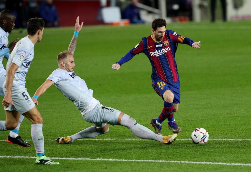 Liionel Messi skips a challenge from Valencia's Uros Racic. Reuters