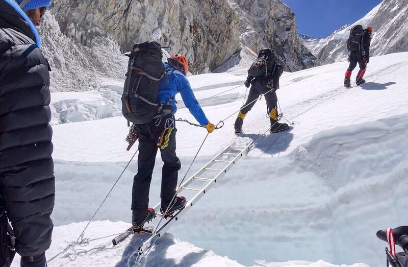 The team of Armed Forces use a ladder to cross a crevasse during a bid to climb Everest.