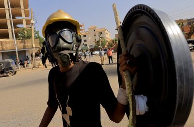 A protester in Khartoum wearing a gas mask to protect against tear gas launched by the security forces. Reuters