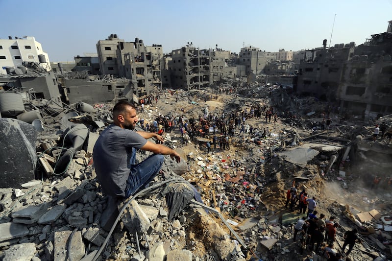 A man sits on the rubble of buildings that were targeted by Israeli air strikes at Jabalia refugee camp in Gaza. AP Photo