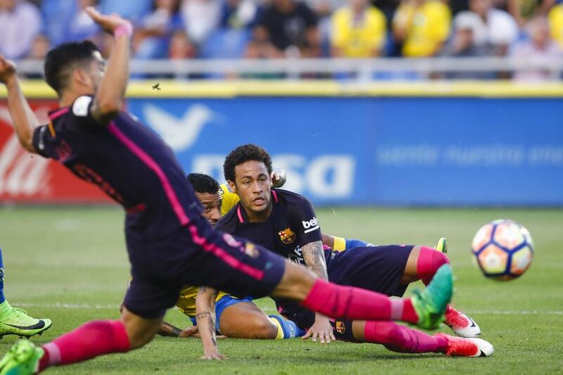 Barcelona’s Neymar, centre, watches the ball. Lucas de Leon / AP Photo