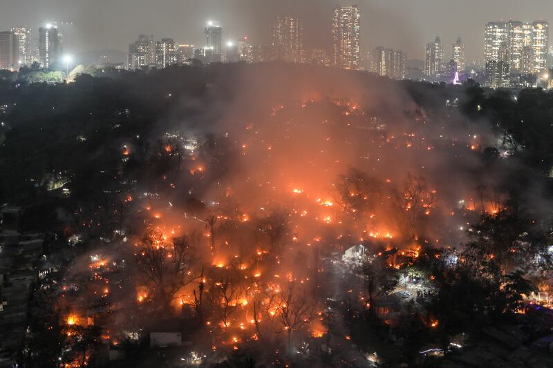 Smoke billows after a level-three fire broke out inside the Appapada slums in Mumbai, India. EPA