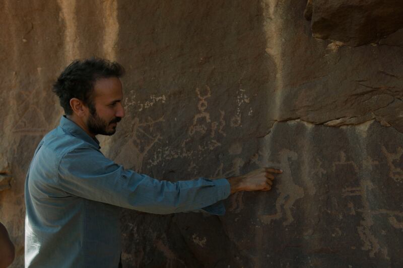 A scene from the documentary in which archaeologist Yan Axoy explores the city's rock art