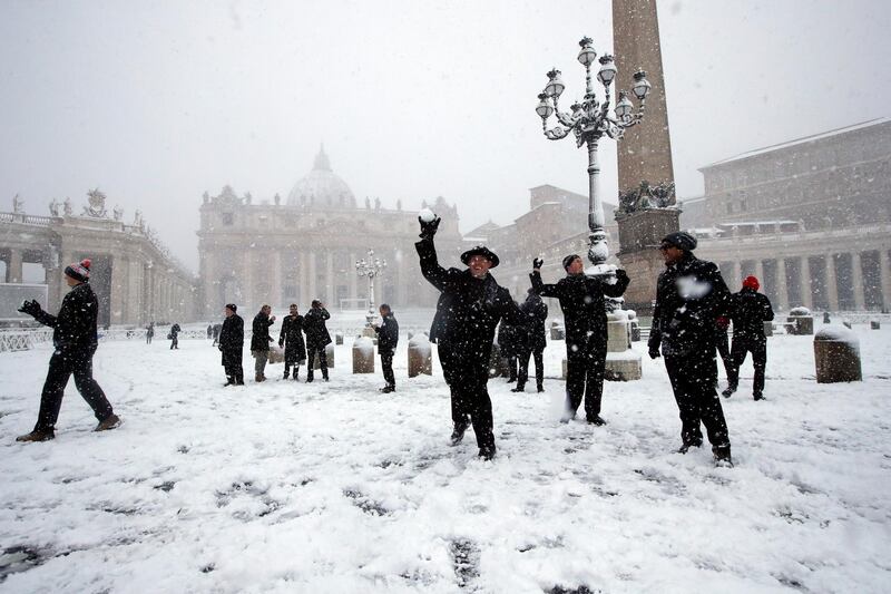 Shawn Roser, from Venice, Florida, a student at the North American college in Rome, throws a snowball as he plays in a snow blanketed St Peter's Square at the Vatican in Rome on February 26, 2018. Alessandra Tarantino / AP Photo