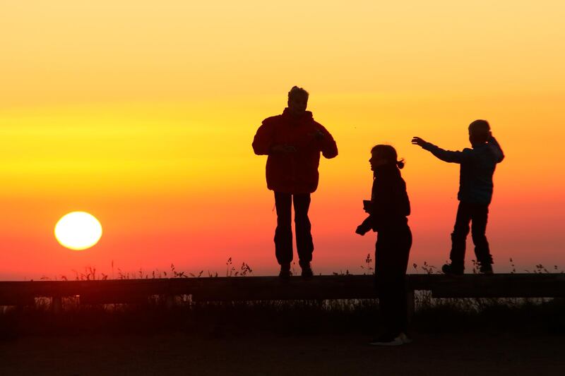 People see the sunrise on the mountain Brocken in Schiere, Germany. AP