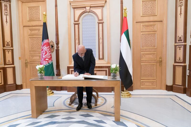 ABU DHABI, UNITED ARAB EMIRATES - March 17, 2019: HH Sheikh Mohamed bin Zayed Al Nahyan, Crown Prince HE Ashraf Ghani, President of Afghanistan (C), signs the visitors book during a reception at the Presidential Palace.  

( Rashed Al Mansoori / Ministry of Presidential Affairs )
---