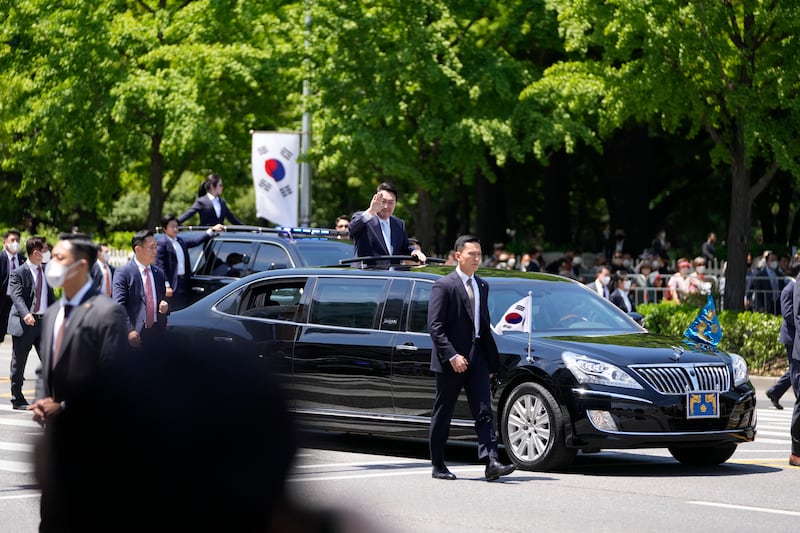 Mr Yoon waves from a car after the inauguration ceremony. AP 