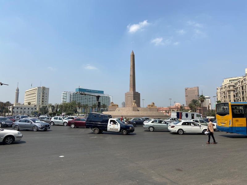The crowded Tahrir Square roundabout is full of cars, taxis, motorcycles, buses - and people.