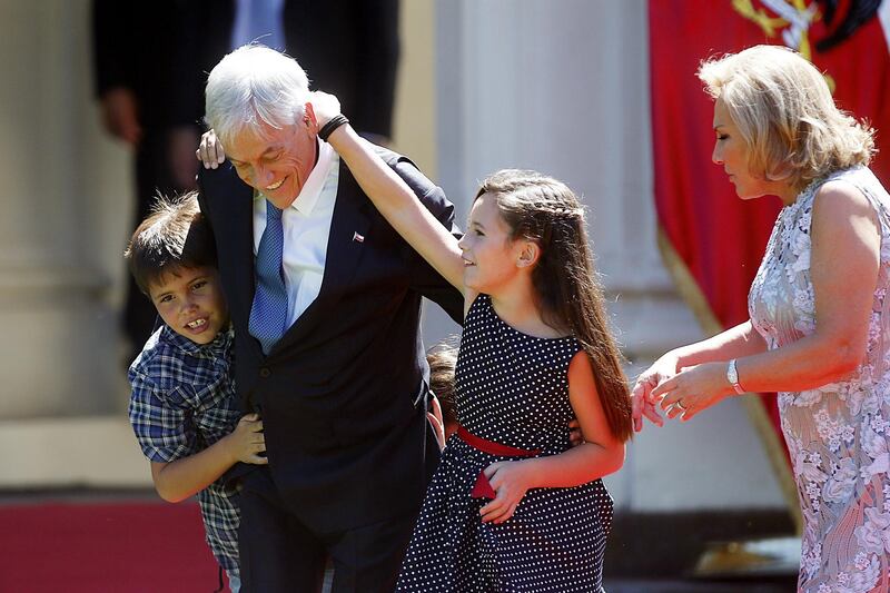 Chilean president Sebastian Pinera  and first lady Cecilia Morel play with their grandchildren as they arrive for an official lunch at the Cerro Castillo Palace in Vina del Mar, Chile.  Esteban Garay / EPA