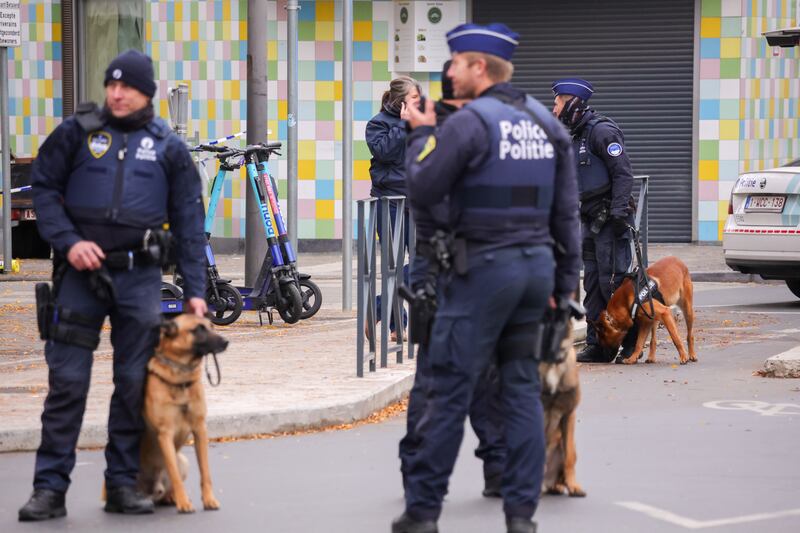 Belgian police officers secure the area where gunman Abdesalam Lassoued was shot dead in Brussels. EPA