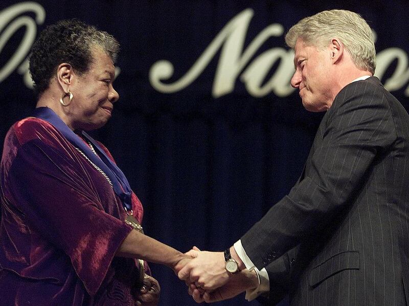 US President Bill Clinton, right, congratulates Dr Maya Angelou, left, after presenting her with the National Medal of Arts during ceremonies at Constitution Hall in Washington, DC on December 20, 2000. Stephen Jaffe / AFP