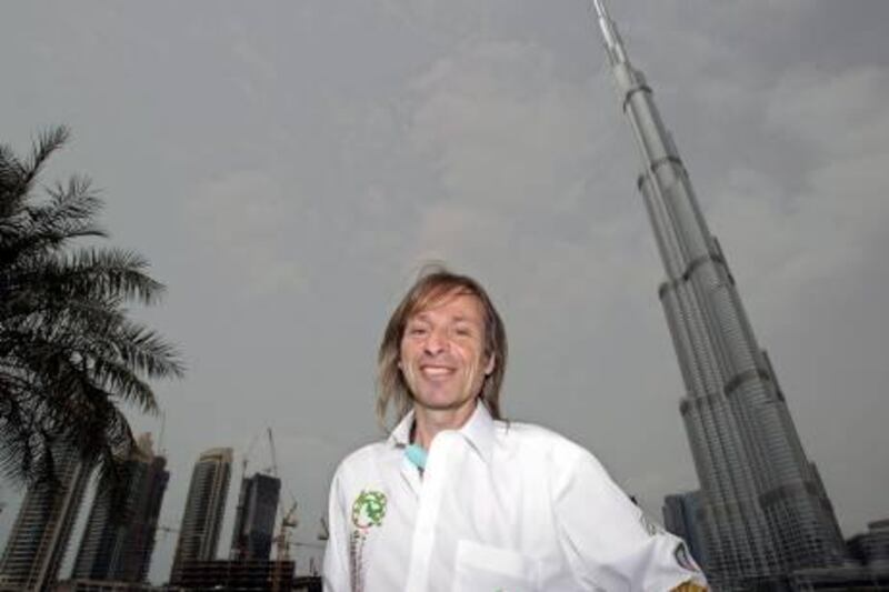 French climber Alain Robert, also known known as the "French Spiderman",  poses in front of Burj Khalifa, the world's tallest tower which he plans to climb, Monday March 28, 2011, in Dubai, United Arab Emirates. (AP Photo/Kamran Jebreili) *** Local Caption ***  XKJ102_Emirates_Dubai_French_Spiderman.jpg