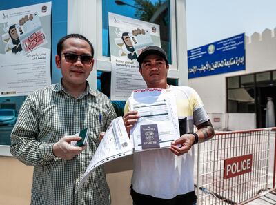 Abu Dhabi, U.A.E., August 1, 2018.
Amnesty seekers at the Shahama Police Centre.  (L-R) Rustono Drmo from Indonesia-39 and Ryan Baliente from the Philippines-37 with their amnesty papers.
Victor Besa / The National
Section:  NA
Reporter:  Haneen Dajani