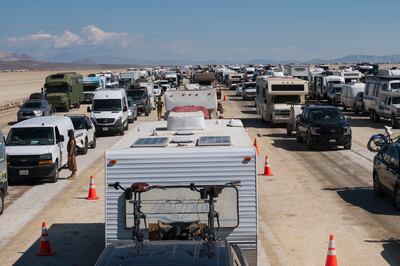 Vehicles line up to leave the Burning Man festival on Tuesday after heavy rains. AP