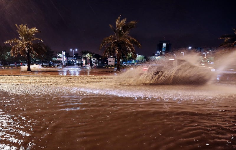 People drive cars on the flooded main road of the Daeya area of Kuwait city. AFP