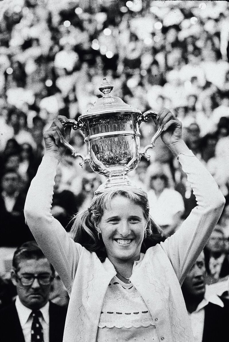 16-year-old American tennis phenom Tracy Austin smiles as she holds her trophy overhead after winning the US Open at the West Side Tennis Club, Forest Hills, New York, September 9, 1979. Austin defeated Chris Evert Lloyd to become the youngest champion in the tournament's history. (Photo by Fred R. Conrad/New York Times Co./Getty Images)