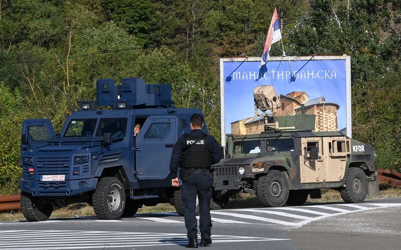 Armed Kosovan police officers secure a road near the village of Banjska. EPA