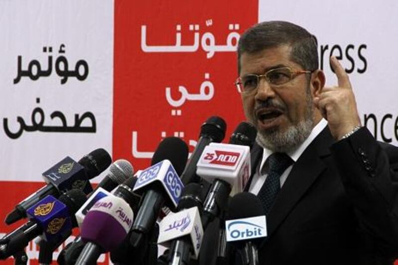 Muslim Brotherhood presidential candidate Mohammed Mursi gives a press conference on June 14, 2012, in Cairo. Mursi said on June 14 that he respected the rulings of Egypt's top court after it rejected a law that would have barred his presidential rival and found the Islamist-led parliament illegitimate. AFP PHOTO / PATRICK BAZ
 *** Local Caption ***  772616-01-08.jpg