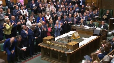 Members of parliament applaud Prime Minister Boris Johnson as he leaves at the end of his last weekly Prime Minister's Questions session in the House of Commons. AFP