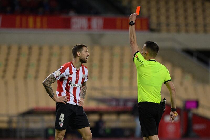 Athletic Bilbao's Spanish defender Inigo Martinez reacts after receiving a red card by Spanish referee Xavier Estrada Fernandez. AFP