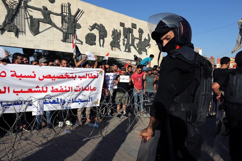 epaselect epa06901526 Iraqi riot forces stand guard ahead of Iraqi protesters during a demonstration  at al-Tahrir square, central Baghdad, Iraq, 20 July 2018. According to media reports dozens of protesters were injured in the clashes that followed the demonstration by thousands of Iraqis over unemployment, the rising cost of living and lack of services in Baghdad, as the Iraqi government had deployed a significant amount of military and police forces in various provinces in southern Iraq and areas in Baghdad.  EPA/AHMED JALIL