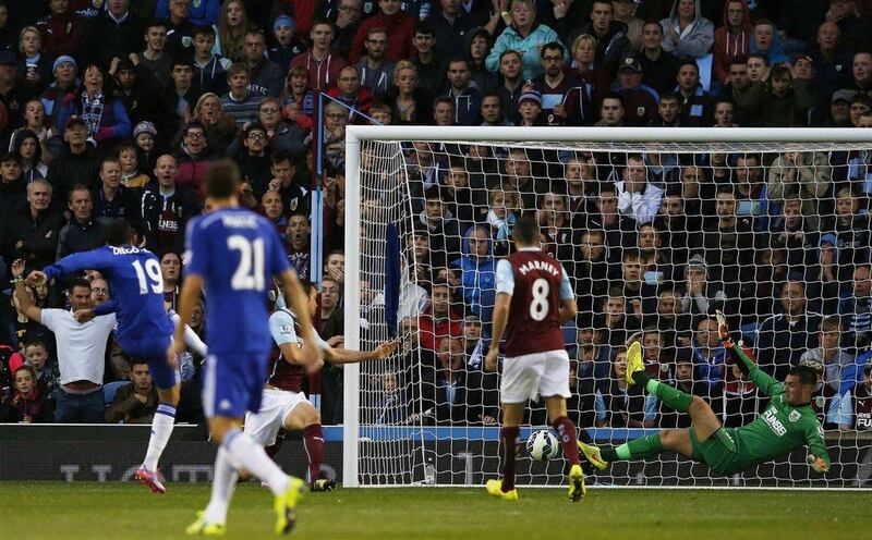 Chelsea's Diego Costa, left, scores past Burnley's Tom Heaton to equalise 1-1 during their Premier League match on Monday night. Andrew Yates / Reuters  