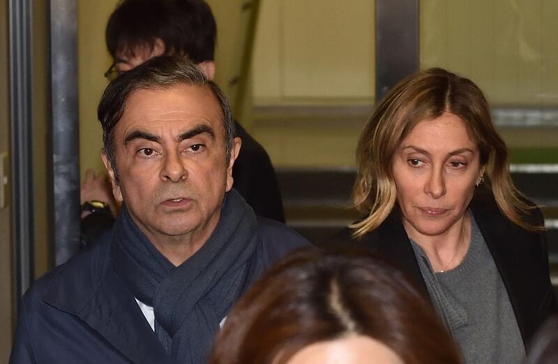 Former Nissan Chairman Carlos Ghosn (L) and his wife Carole (R) leave the office of his lawyer Junichiro Hironaka in Tokyo on April 3, 2019 Tokyo prosecutors are considering pressing a fresh charge against Carlos Ghosn, local media said on April 3 as the former Nissan boss announced on Twitter he would be giving his side of the story. / AFP / Kazuhiro NOGI
