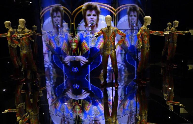 The Ziggy Stardust jumpsuit designed by Freddie Burretti (1972) is reflected in mirrors of an installation at the David Bowie exhibition at the Martin-Gropius-Bau museum in Berlin, seen during a preview on May 19, 2014. The retrospective that was on display at London’s Victoria and Albert Museum before will be running in the German capital from May 20 to August 10, 2014. Johannes Eisele / AFP photo