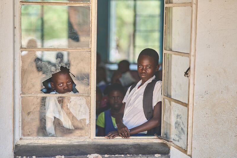 Pupils look out from a school window at Mabale Primary near Hwange National Park in Hwange. AFP