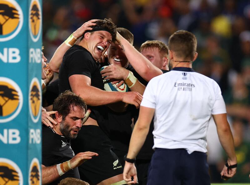 New Zealand's Scott Barrett celebrates with teammates after scoring their fourth try. Reuters