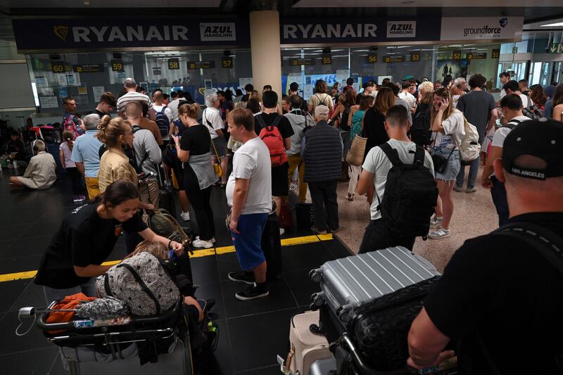 Passangers queue at El Prat airport in Barcelona. About thirty Ryanair flights were cancelled in Spain on Thursday, while 124 others were delayed, on the fourth day of a strike by the company's cabin crew. AFP