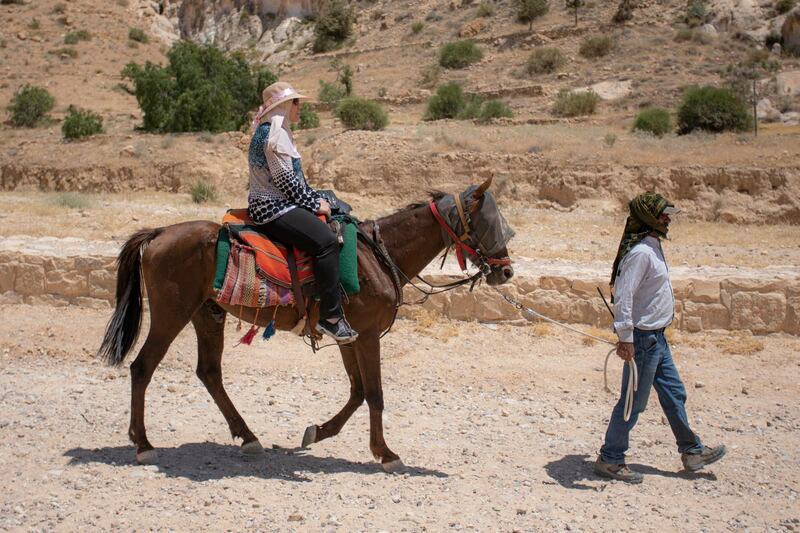 A domestic tourist rides a horse during a visit at the reopened Petra archeological site. EPA